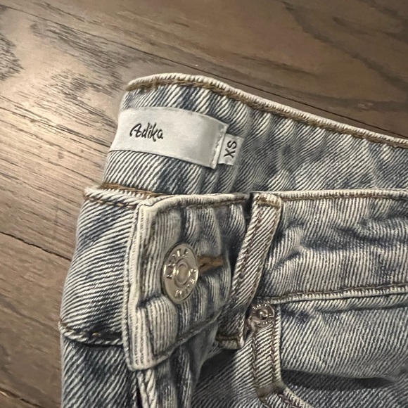 Medium wash straight leg jeans with butterfly details and distressed bottom. - Picture 3 of 3